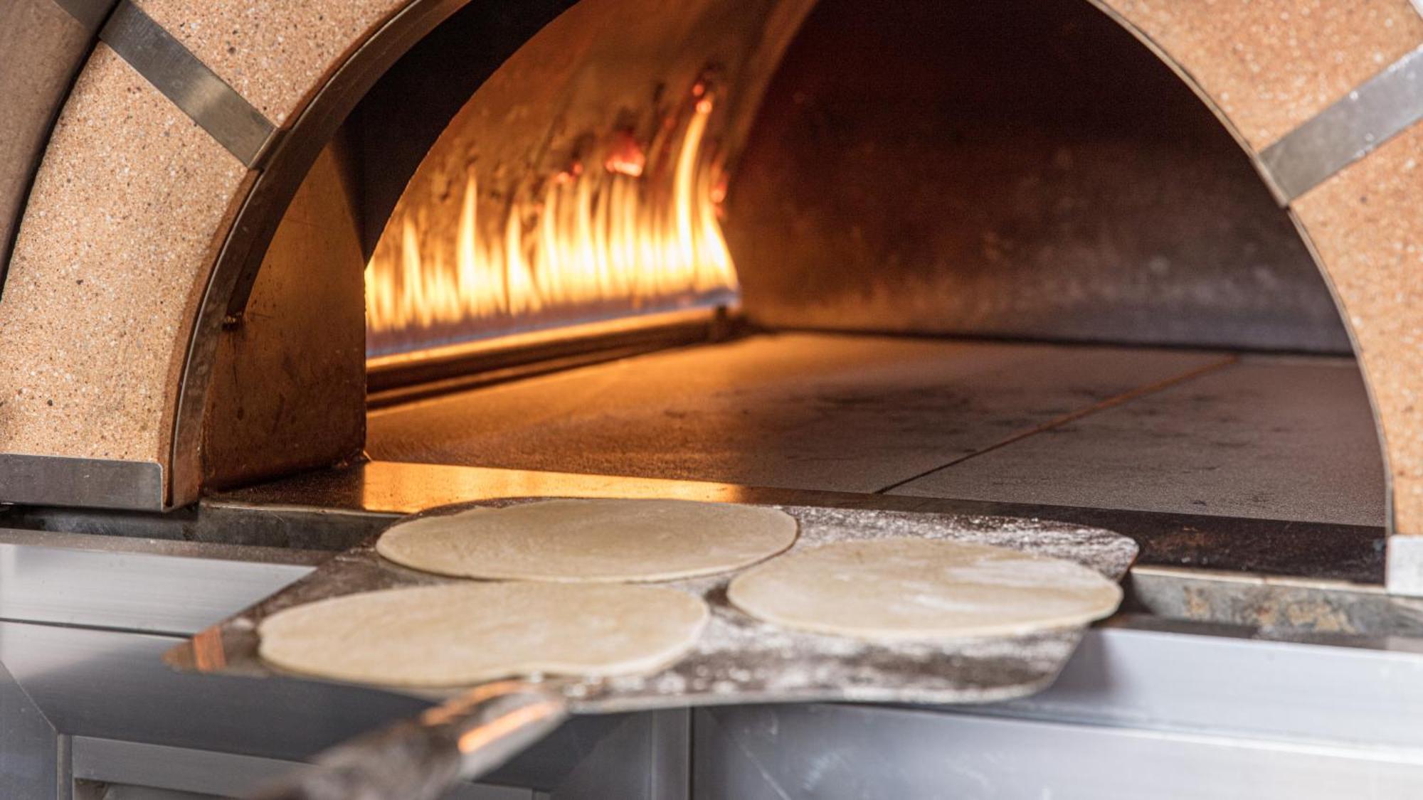The Abdali Boulevard Hotel Amman Exterior foto Pizza dough in a wood-fired oven